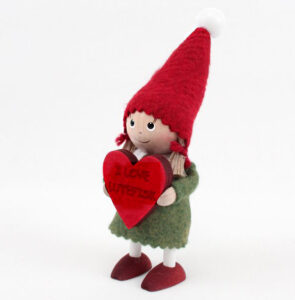Small tomte girl holding a heart sign that says, "I love lutefisk."