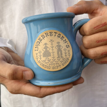 Hands holding the ingebretsen's deneen mug